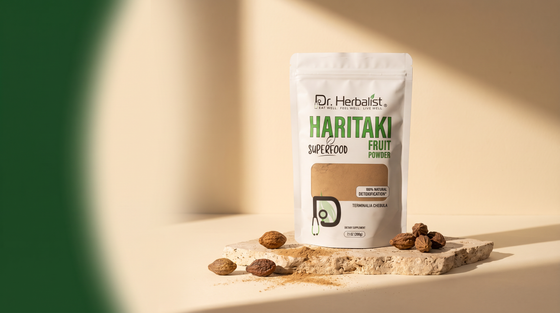 Dr. Herbalist Haritaki Fruit Powder pouch with dried haritaki fruits on stone surface